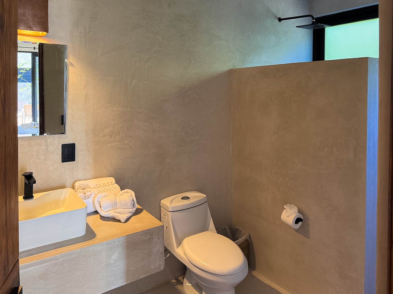 Baño de microcemento con lavabo y espejo